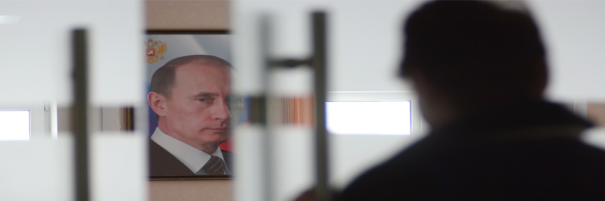 A portrait of Vladimir Putin, the President of Russia, hangs on the wall in the room